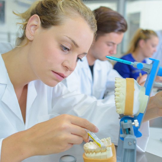 Various dental technicians making dentures