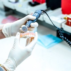 A dental technician crafting a partial denture