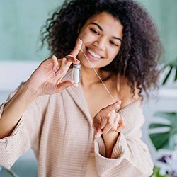 Smiling woman eating healthy breakfast at home