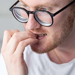 Closeup of man biting his nails